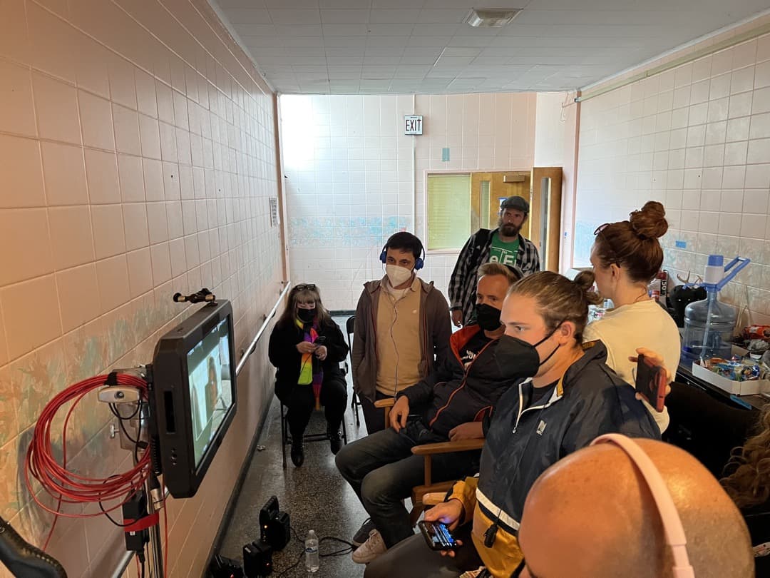 Behind the scenes photo 41 from Clone Cops production showing cast watch a scene from video village